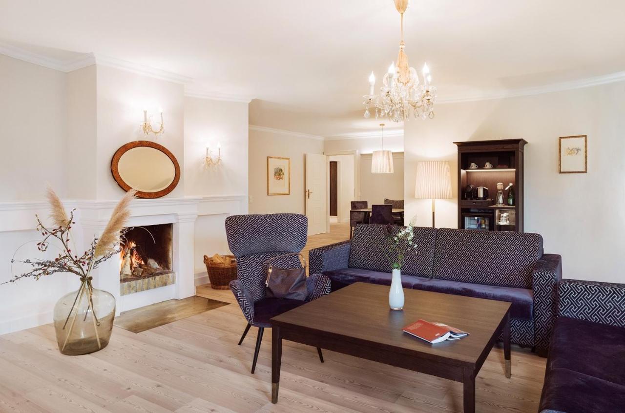 Imlauer Hotel Schloss Pichlarn Aigen im Ennstal Exterior photo A living room with a fireplace